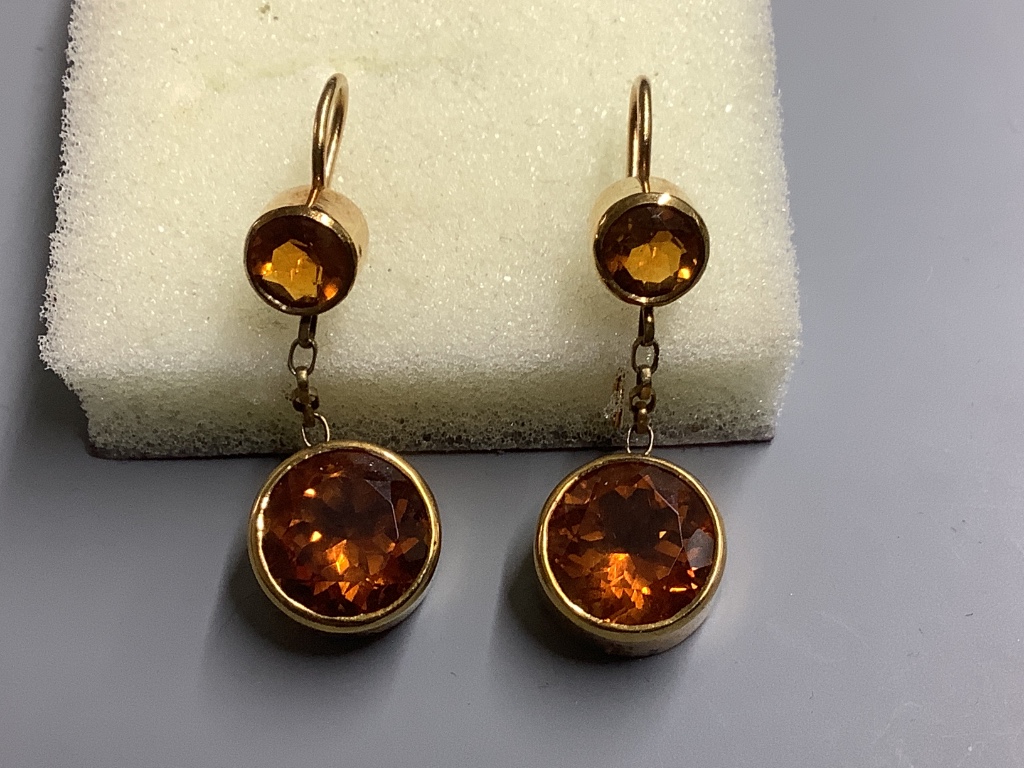 A pair of yellow metal and two stone citrine set drop earrings